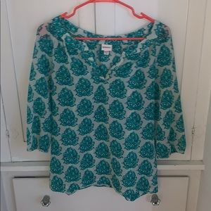 White shirt with with a green flower